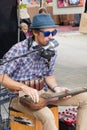 Busker singing and playing guitar music in Eumundi, Queensland, Australia