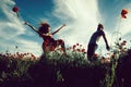 Euphoria. man and girl in red poppy field