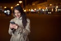 Euphoric woman using her smart phone and smiling to good news message.Happy woman typing text message on a smart phone Royalty Free Stock Photo