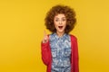 Eureka, I know answer! Portrait of amazed inspired woman with curly hair pointing finger up