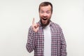 Eureka! Portrait of excited joyful bearded man pointing finger up, looking inspired with found answer. white background