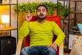 Thoughtful inspired Indian man make Eureka gesture raises finger came up creative plan at home