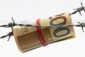 200 euro bank notes rolled up and hanging on barbed wire Royalty Free Stock Photo