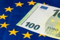 100 euro banknote against the background of the flag of the European Union, EU financial concept, Joining the euro zone, Common Royalty Free Stock Photo