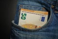 Euro banknote in the front pocket of blue jeans. Cash in your pocket. Royalty Free Stock Photo