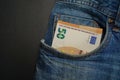 Euro banknote in the front pocket of blue jeans. Money in your pocket, cash. Royalty Free Stock Photo