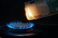 100 euro banknote on a gas burner. The concept of cost for natural gas. Energy crisis. High cost, gas price. Sanctions Royalty Free Stock Photo