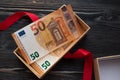 Euro banknote in gift box and red ribbon Royalty Free Stock Photo