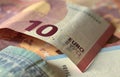 Euro banknote of ten euros, mix of banknotes as background, close-up Royalty Free Stock Photo