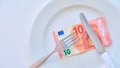 Euro banknote on a white plate, cash in Europe, the cost of lunch in the restaurant Royalty Free Stock Photo