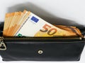 50 Euro banknotes in a black leather wallet close-up. The concept of cash, cash savings, prosperity. Euromoney