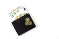 Euro banknotes in black men`s purse. A few Euro coins. On white Royalty Free Stock Photo