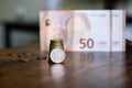 Euro banknotes of different denominations and coins lie on a wooden table Royalty Free Stock Photo