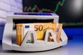 Euro banknotes in the electronic money counter machine. Cash money counter with 50 euro banknotes in it Royalty Free Stock Photo