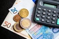 Euro banknotes,euro coins and calculator. Royalty Free Stock Photo