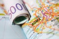 Euro banknotes on a geographical map of Roma Royalty Free Stock Photo