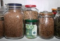 Euro banknotes in a glass jar among other jars with cereals and dried fruits. Royalty Free Stock Photo