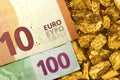 Euro banknotes on golden nuggets close up Royalty Free Stock Photo