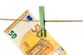 Euro banknotes hanging on a clothesline against white background. Money laundering concept Royalty Free Stock Photo