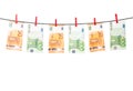 Euro banknotes hanging on a clothesline against white background. Euro money with red clothes pegs on rope. Money Laundering euro Royalty Free Stock Photo