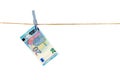 Euro banknotes hanging on a clothesline against white background. Money laundering concept Royalty Free Stock Photo