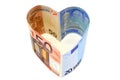 Euro banknotes in heart shape on white background