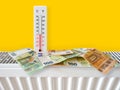 Euro banknotes on home heating radiator with thermometer. Energy crisis and expensive heating costs for winter season. Royalty Free Stock Photo