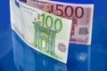 500, 100 euro banknotes isolated on a blue background. Close-up. Royalty Free Stock Photo