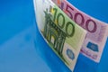 500, 100 euro banknotes isolated on a blue background. Close-up. Side view. Royalty Free Stock Photo