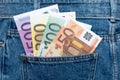 Euro banknotes in jeans back pocket. Forgotten money, nest egg. Concept of saving or spending money. Euro bills falling out. Easy Royalty Free Stock Photo