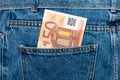 Euro banknotes in jeans back pocket. Forgotten money, nest egg. Concept of saving or spending money. Euro bills falling out. Easy Royalty Free Stock Photo