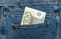 Euro banknotes in jeans back pocket. Forgotten money, nest egg. Concept of saving or spending money. Euro bills falling out. Easy