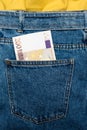 Euro banknotes in jeans back pocket. Forgotten money, nest egg. Concept of saving or spending money. Euro bills falling out. Easy Royalty Free Stock Photo