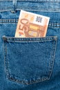 Euro banknotes in jeans back pocket. Forgotten money, nest egg. Concept of saving or spending money. Euro bills falling out. Easy Royalty Free Stock Photo