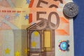 50 Euro banknotes 1 krone coin blue background