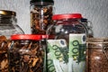 Euro banknotes lie in a glass jar among other jars of cereals and dried fruits. Royalty Free Stock Photo