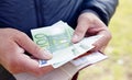 Euro banknotes in male hands counting the money, calculating