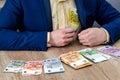 Euro banknotes in male hands and on table Royalty Free Stock Photo