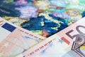 Euro banknotes on the map of Europe, selective focus