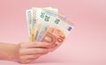 Euro banknotes money in female hands on pink background. Business Concept and Instagram Royalty Free Stock Photo