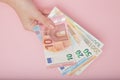 Euro banknotes money in female hands on pink background. Business Concept and Instagram Royalty Free Stock Photo