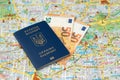 Euro banknotes money with Ukrainian travel passport on a Berlin city map background