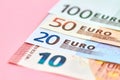 10, 20, 50, 100 Euro banknotes on pink background. Close-up, selective focus Royalty Free Stock Photo