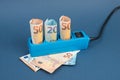 Euro banknotes in a power outlet, rising prices, expensive green electricity Royalty Free Stock Photo