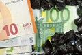 Euro banknotes on raw coal nuggets, bills on coal, power of money and ore Royalty Free Stock Photo