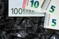 Euro banknotes on raw coal nuggets, bills on coal, power of money and ore Royalty Free Stock Photo