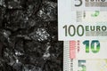 Euro banknotes on raw coal nuggets, bills on coal, power of money and ore Royalty Free Stock Photo