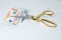 Euro banknotes and scissors on light marble table Royalty Free Stock Photo
