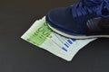 Euro banknotes under shoes