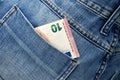 Euro bill in the back pocket of jeans. Ten Euro in a denim pocket